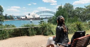 Woman looking at Sydney Harbour Bridge and Opera House